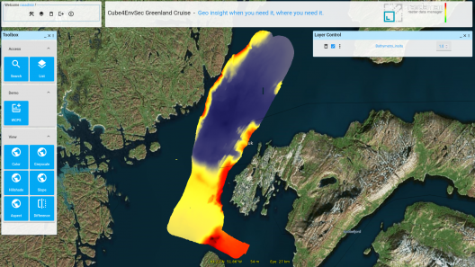 In mid-April the research vessel "Sanna" has explored Greenland's coastal underwater landscape while being connected to the EarthServer datacube federation. Federation members worldwide were able to use realtime bathymetry data, and on board the federation holdings – satellite, weather, bedrock, and more datacubes – were readily available to the scientists for analysis while still on board.  Sanna is a state-of-the art research vessel operated by the Greenland Institute of Natural Resources (GINR). In a demonstration conducted jointly by GINR and Constructor University as part of NATO´s Science for Peace and Security (SPS) project Cube4EnvSec, Sanna showed the way forward in seamlessly interconnected services, including on-the-fly data homogenization and intercontinental distributed data fusion, all fully automated. Cube4EnvSec has set out to demonstrate the added value of federated, AI-enabled datacube services for planetary-scale joint use of Big Earth Data.  “We routinely harvest from worldwide data sources into datacubes – you wouldn’t believe how heterogeneous their data are, and how much the mileage of metadata completeness and conformance varies”, explains Prof. Dr. Peter Baumann, coordinator of Cube4EnvSec. “Main task of our rasdaman datacube engine is to push all technicalities behind the curtain and give support, such as with AI-Cube chatbots, so that experts gain productivity and non-experts first time get access.”  The seas and fjords around Greenland and neighbouring countries are of vital economic and ecological importance. Fishing for shrimp and Greenland halibut is Greenland's dominant industry, and the submarine slopes and canyons are hotspots for marine biodiversity, some of which is fragile. The terrain below the sea surface is an important factor. The integration of highly dynamic marine data into high-performance maritime data services remains a challenge. For powerful support of mariners during navigation in general, these maritime data need to be combined with environmental data like sea floor properties, water temperature, currents, waves, and ice conditions. For scientific and fishery further relevant parameters such as plankton blooms, sea surface temperature, etc. need to be integrated in their most up-to date version from various and diverse sources.  In Cube4EnvSec, the participants Constructor University, Tel Aviv University, GINR, and Istanbul Aydin University are building a datacube federation of 3D x/y/t and 4D x/y/z/t datacubes on forecast, nowcast, and historical data updated automatically from a variety of sources. Datacubes offered include radar and optical satellite data, derived products for environmental monitoring and aviation-safety (such as wind, clouds, and volcanic ash), consolidated observations on global lightning occurrences, and more. This is federated, among others, with EarthServer and EO-Cube, the IEEE GRSS Earth datacube service in the US.  GINR is collaborating with the international network of the Arctic Pilot where further datacubes are planned to be added soon. “Specifically for Greenland, it is important to have terrain characteristics such as slope, aspect, and ruggedness, ready for mix & match with a variety of other data”, said Karl Zinglersen, head of department Environment at  GINR.  Research vessel “Sanna” is operating in the fjords and offshore waters of East Greenland in the Denmark Strait. Marine scientists on board are investigating Blue Carbon flux properties of the ocean, and biomass health and ocean pollution to assess impacts from climate change and industrial environment. Their sampling relies on supporting information obtained from satellites, in-situ data, AI models and spatio-temporal analytical capabilities which in future can be offered in a standards-compliant way through the rasdaman datacube services. Real-time captured bathymetry in the Sanna onboard datacube (source: rasdaman/Constructor University) 